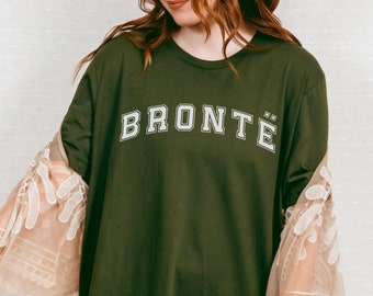 May include: A green long-sleeved t-shirt with the word "BRONTË" printed in white on the front.