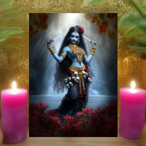 May include: A framed artwork depicting a blue-skinned deity with multiple arms, adorned with jewelry and a garland of skulls. The artwork is set against a backdrop of a waterfall and red flowers, with two lit pink candles and gold decorative objects.