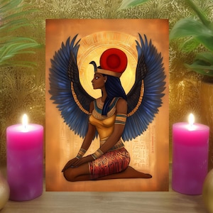 May include: An artistic print of an Egyptian goddess with blue wings, a red sun headdress, and gold accents. The artwork is framed by two lit pink candles, a gold vase, and a potted plant, set against a gold patterned background.