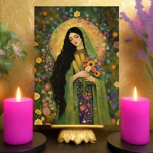 May include: An artistic print of a woman with long black hair, holding flowers and corn, set against a floral background. The print is displayed on a gold stand, flanked by two lit pink candles and decorative vases.