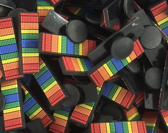 Peut inclure: Un tas de poignées de téléphone arc-en-ciel avec des bases noires. Les poignées sont en silicone et ont une surface texturée.