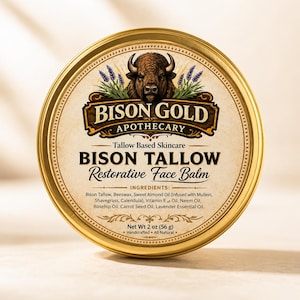 May include: A round, gold-colored tin of Bison Tallow Restorative Face Balm. The label features a bison illustration and the text "Bison Gold Apothecary". The tin contains 2 oz (56 g) of product and lists ingredients like bison tallow and lavender essential oil.