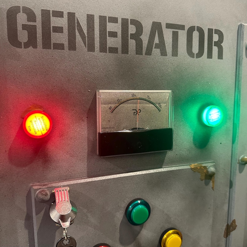 May include: A metal panel with the word "GENERATOR" printed in black. The panel has a round red light, a round green light, a round black gauge with a needle pointing to 50, a green button, and a yellow button.