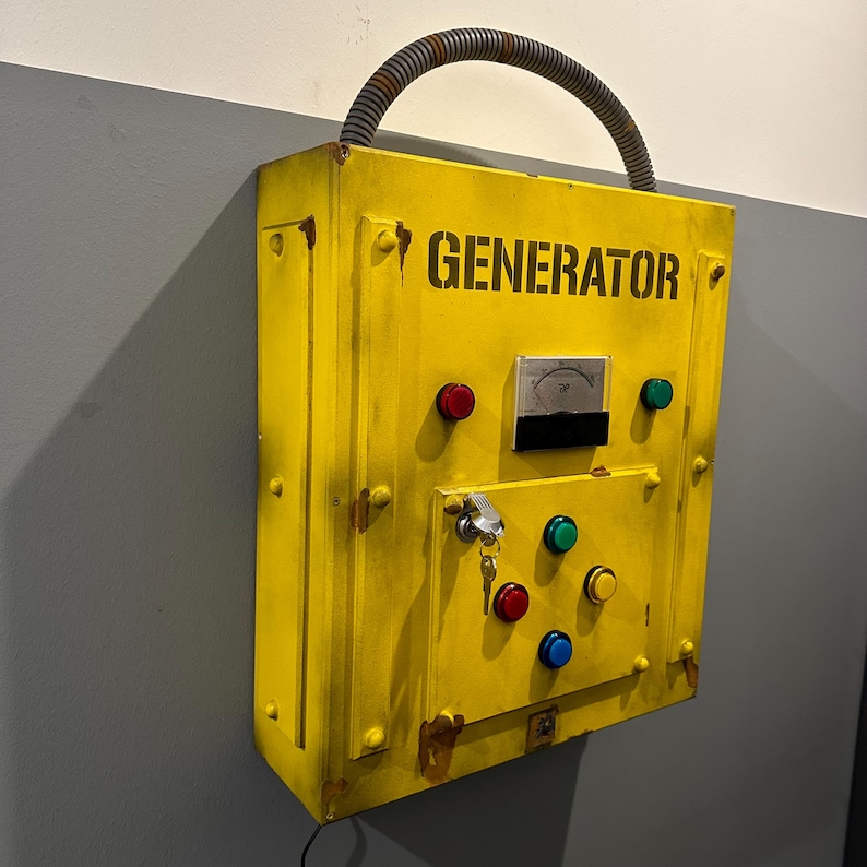 May include: A yellow metal box with the word "GENERATOR" printed on the front. The box has a variety of buttons, a keyhole, and a small gauge.