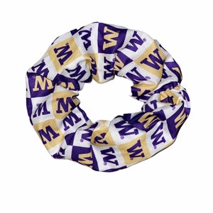 May include: Purple and gold scrunchie with a repeating pattern of the letter "W" on a white background.