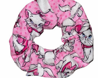 May include: Pink scrunchie with a white polka dot pattern and a repeating image of a white cat with a pink bow.