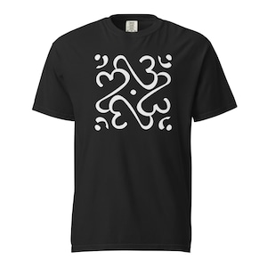 May include: Black t-shirt featuring a white abstract design. The design is a repeating pattern of interconnected heart-like shapes and dots. The shirt has a crew neck and short sleeves. The fabric appears to be a soft cotton blend.