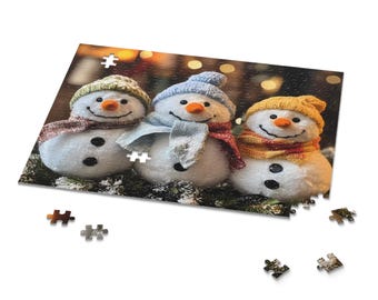May include: A jigsaw puzzle featuring three snowmen with orange carrot noses, black button eyes, and wearing colorful scarves and knit hats. The snowmen are set against a blurred background of lights and greenery.