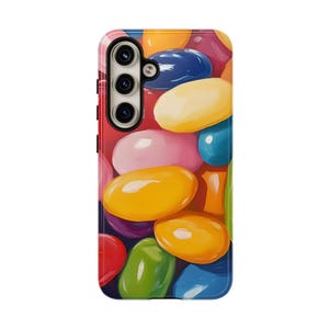 May include: A smartphone case featuring a vibrant, colorful design of jelly beans. The case showcases a variety of colors, including red, pink, yellow, green, blue, and purple. The case has a camera cutout and buttons on the side.