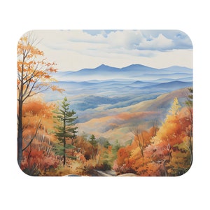 May include: A watercolor painting of a mountain landscape with fall foliage. The scene features a winding road leading up to a mountain range in the distance. The trees are a mix of orange, yellow, and red.
