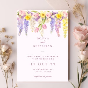 May include: A wedding invitation with a floral design featuring pink, yellow, and purple flowers. The invitation reads "Donna and Sebastian Invite you to celebrate their wedding on 17 Oct 99 123 Anywhere St., Any City, St 12345 reception to follow."