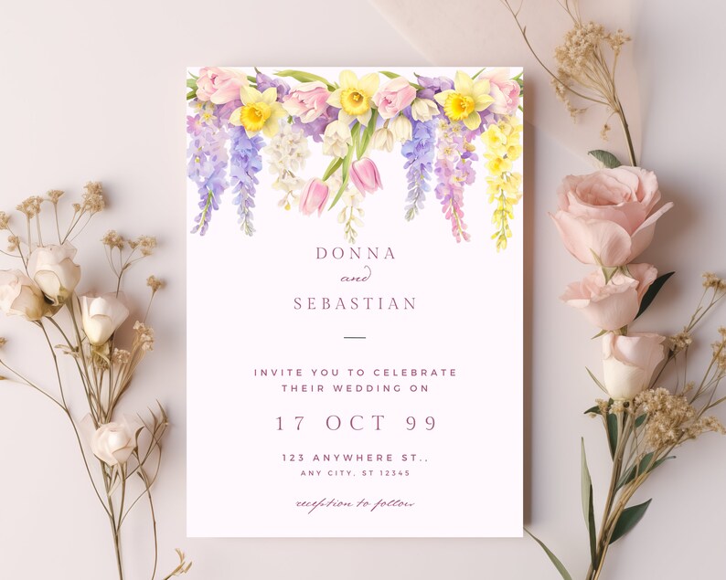 May include: A wedding invitation with a floral design featuring pink, yellow, and purple flowers. The invitation reads "Donna and Sebastian Invite you to celebrate their wedding on 17 Oct 99 123 Anywhere St., Any City, St 12345 reception to follow."