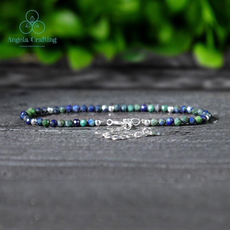 May include: A delicate anklet made with small blue and green gemstone beads and a silver clasp.