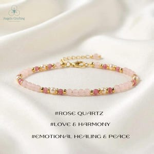 May include: A delicate bracelet featuring alternating light pink rose quartz beads, smaller dark pink beads, white pearls, and gold-toned metal spacers. The piece includes a gold-toned lobster clasp and chain extender. Text reads: #ROSE QUARTZ #LOVE & HARMONY #EMOTIONAL HEALING & PEACE.