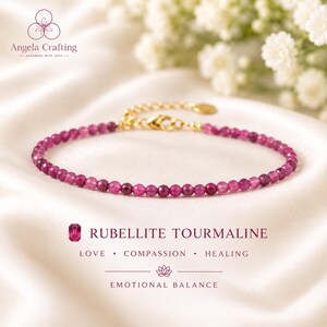 May include: A delicate bracelet featuring small, faceted, deep pink rubellite tourmaline beads strung on a gold-toned chain with a lobster clasp. Text on the image reads: Angela Crafting, RUBELLITE TOURMALINE, LOVE, COMPASSION, HEALING, EMOTIONAL BALANCE.