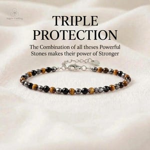 May include: A beaded bracelet featuring alternating brown tiger eye, black obsidian, and metallic gray hematite stones. The bracelet includes a silver-toned metal chain extension with a lobster clasp and a small heart-shaped charm at the end.