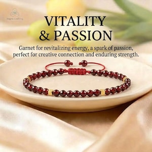 May include: A red garnet beaded bracelet with small gold-toned square spacers and a red adjustable cord closure. The text VITALITY & PASSION and Garnet for revitalizing energy, a spark of passion, perfect for creative connection and enduring strength.
