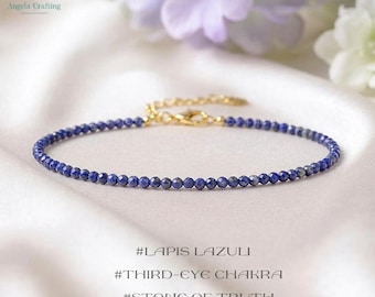 May include: A delicate bracelet featuring small, faceted deep blue lapis lazuli beads arranged in a circular strand. The piece includes a gold-toned metal chain extension and a lobster claw clasp. Text below reads #LAPIS LAZULI #THIRD-EYE CHAKRA #STONE OF TRUTH.