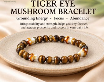 May include: A beaded bracelet featuring brown tiger eye gemstone beads, white and brown mushroom-shaped beads, and small gold-toned metal spacers with clear crystals. The text on the image reads TIGER EYE MUSHROOM BRACELET Grounding Energy Focus Abundance.