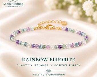 May include: A delicate bracelet featuring small, faceted rainbow fluorite beads in shades of purple, green, and clear white. The bracelet includes a gold-toned metal chain with a lobster clasp and a small heart-shaped charm at the end of the extender.