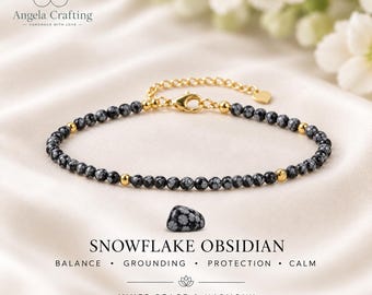 May include: A delicate bracelet featuring small, round, black and white snowflake obsidian beads interspersed with polished gold-tone metal beads. The bracelet includes a gold-tone lobster clasp, an adjustable chain, and a small heart-shaped charm.
