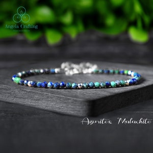 May include: Azurite and malachite gemstone bracelet with silver beads. The bracelet is made with small, round beads of blue azurite and green malachite.