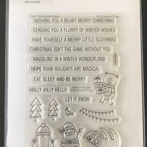 May include: A clear sheet of transparent stamps with a Christmas theme. The stamps feature illustrations of a bear, a sloth, a penguin, Santa Claus, a bird, and a string of lights. The text on the stamps reads "Wishing you a beary merry Christmas", "Sending you a flurry of winter wishes", "Have yourself a merry little slothmas", "Christmas isn't the same without you", "Waddling in a winter wonderland", "Hope your holidays are magical", "Eat, sleep, and be merry", "Holly jolly hello", and "Let it snow".