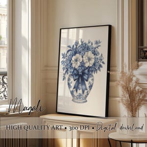 May include: A framed art print showcasing a blue and white floral arrangement in a decorative vase with a bow. The artwork has a vintage aesthetic and includes the text "Magali", "HIGH QUALITY ART", "300 DPI", and "Digital download".