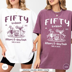 two women wearing t - shirts that say fifty is a beach