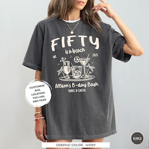 a woman wearing a t - shirt that says fifty is a beach