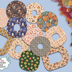 May include: A collection of adhesive overpatches featuring various autumn-themed patterns including pumpkins, owls, leaves, and turkeys. The patches are circular or rounded square shapes with center cutouts. Text reads: NOTE: THESE ARE OVERPATCHES & SOLD INDIVIDUALLY.