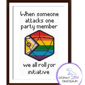 May include: A framed cross-stitch art piece with a brown frame. The artwork features a colorful, pixelated D20 die with rainbow and pride flag colors. Text reads "When someone attacks one party member, we all roll for initiative."