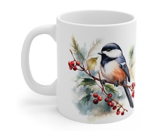May include: White ceramic mug with a watercolor illustration of a black-capped chickadee perched on a branch with red berries. The bird is painted in shades of blue, white, and brown.