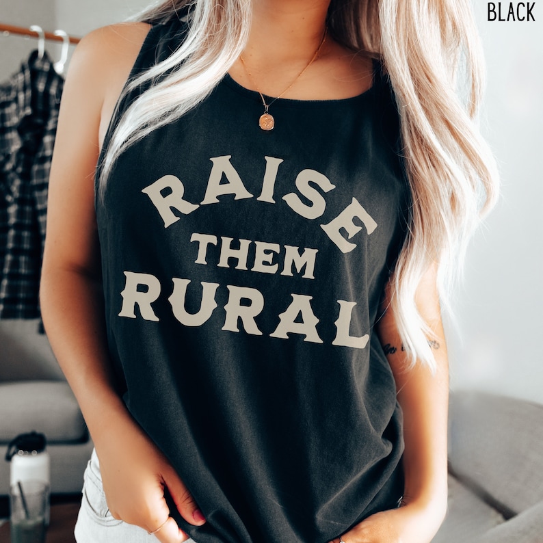 May include: A black tank top with the text "RAISE THEM RURAL" printed in a cream color.