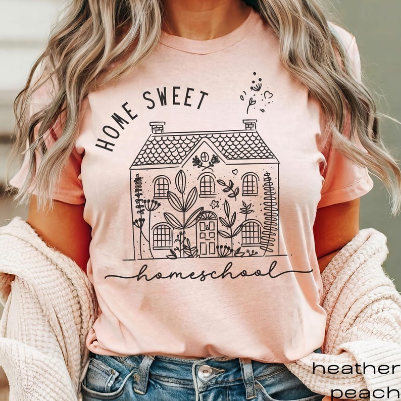 May include: A pink t-shirt with a black graphic of a house with the text "Home Sweet Homeschool" printed on it.