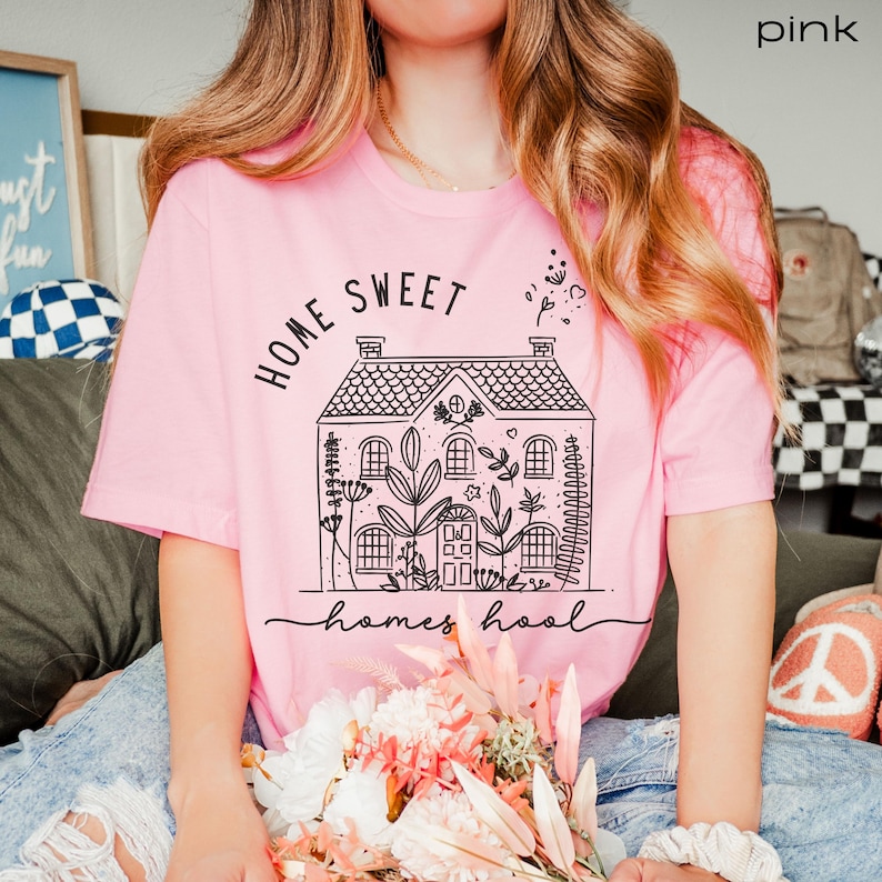 May include: Pink t-shirt with a black graphic of a house with the text "Home Sweet Homeschool" on it.
