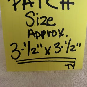 May include: A yellow square with the words "PATCH Size Approx." written in black. Below the text is "3-1/2" x 3-1/2"" in black. The patch is approximately 3.5 inches by 3.5 inches.