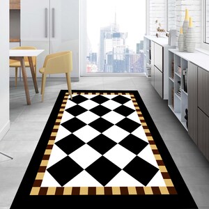 May include: Black and white checkered rug with a brown and beige border. The rug has a diamond pattern and is placed on a tiled floor in a room with white cabinets and a window.