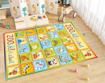 May include: A colorful play mat with a zoo alphabet theme. Each letter of the alphabet is paired with an animal illustration. The mat is rectangular and has a yellow background with green, blue, and red accents.