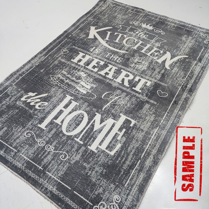 May include: A gray and white kitchen rug with the text "The Kitchen is the Heart of the Home" in a vintage style font.