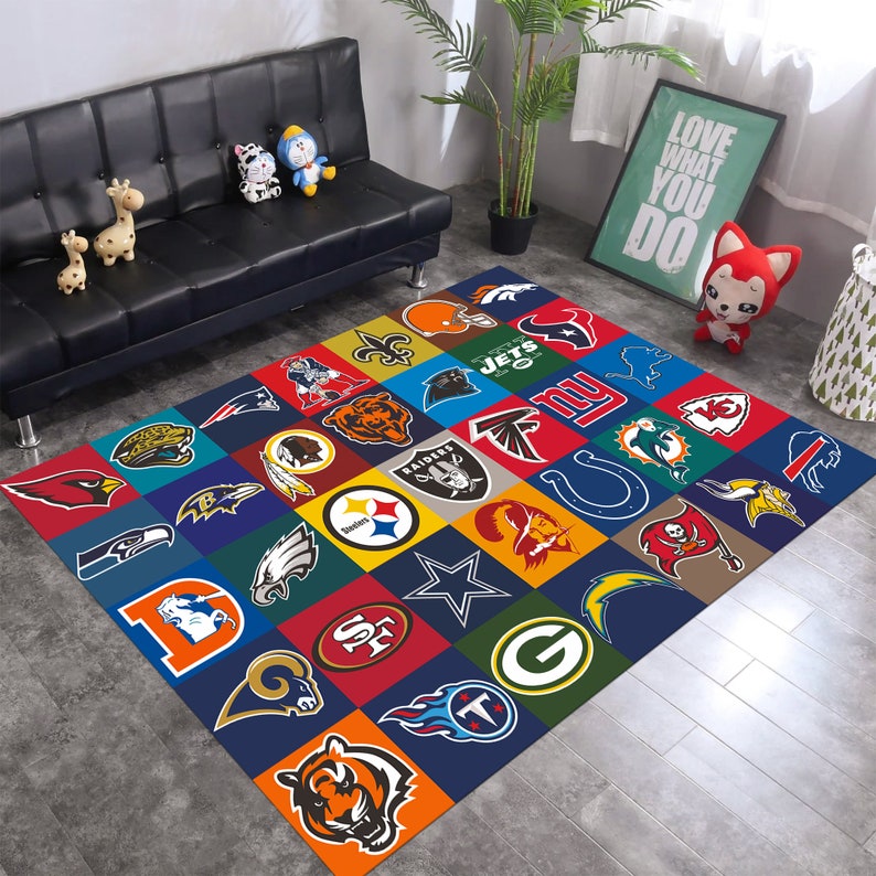 May include: A colorful rug with the logos of different NFL teams. The rug is made of a soft, durable material and is perfect for adding a touch of team spirit to any room.