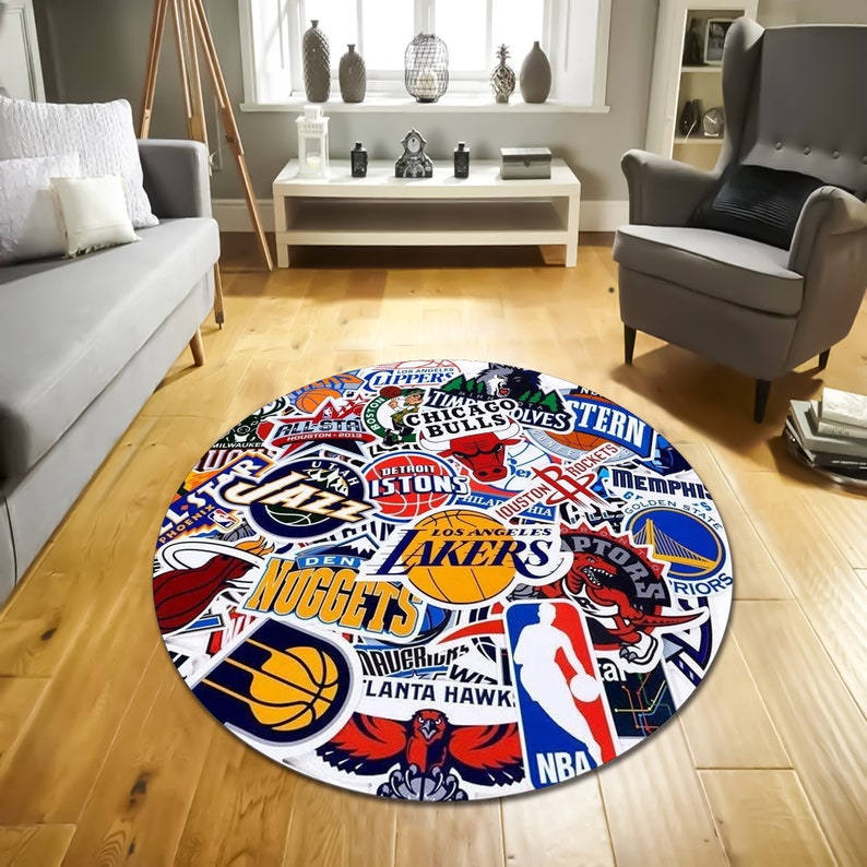May include: Round rug with a white background and a colourful collage of NBA team logos, including the Lakers, Bulls, Celtics, and more.