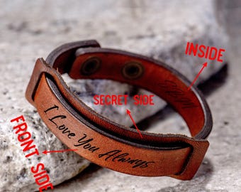 May include: A brown leather bracelet with a snap closure. The bracelet has the words "I Love You Always" engraved on the front side and "Secret Side" engraved on the inside.