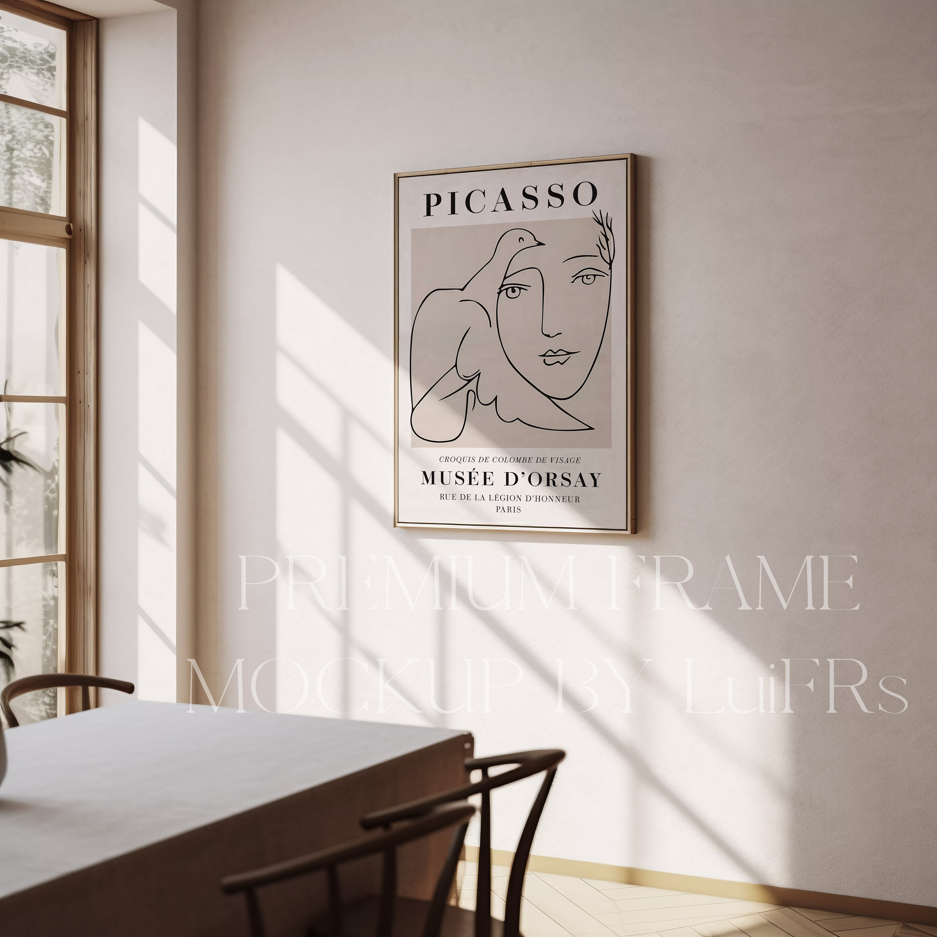 May include: A black and white line drawing of a woman's face with a dove on her shoulder. The artwork is framed in a gold frame and is hanging on a white wall. The text "PICASSO" is at the top of the artwork. The text "CROQUIS DE COLOMEZ DE TESAGE" is below the artwork. The text "MUS&Eacute;E D'ORSAY" is below the text "CROQUIS DE COLOMEZ DE TESAGE". The text "RUE DE LA LEGION D'HONNEUR" is below the text "MUS&Eacute;E D'ORSAY". The text "PARIS" is below the text "RUE DE LA LEGION D'HONNEUR".