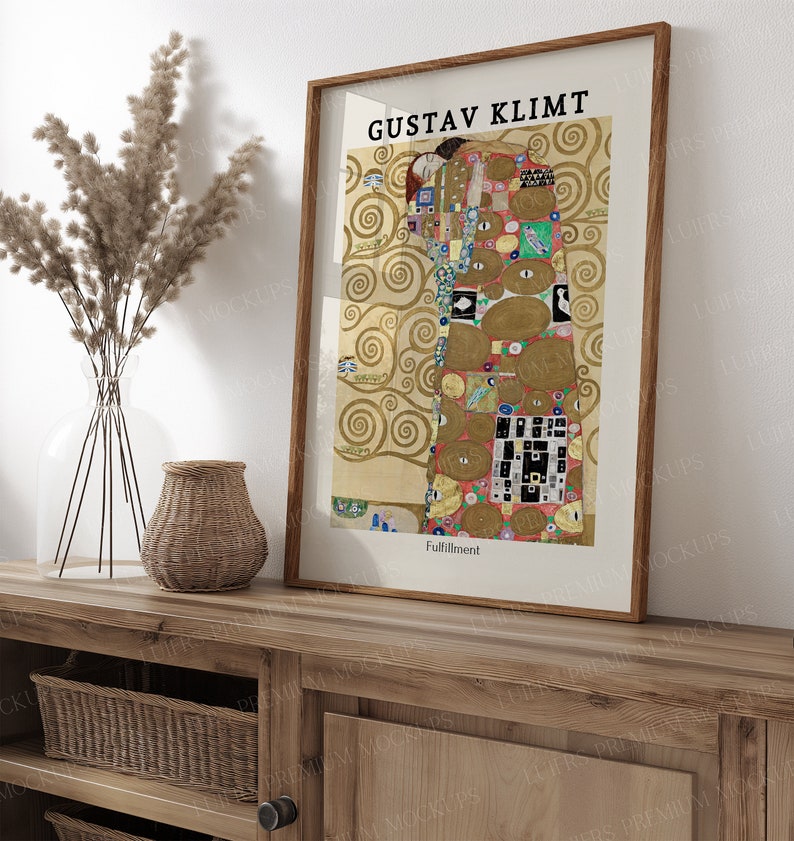 May include: A framed print of Gustav Klimt's "The Tree of Life" painting. The painting features a couple embracing in a colorful, abstract style with a gold background. The frame is brown wood with a white mat.