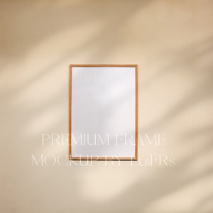 May include: A simple wooden frame mockup on a beige wall with light shadows. The frame is empty and ready for your design.