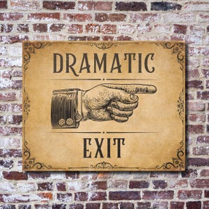 May include: A rectangular sign with the words "DRAMATIC EXIT" in black, vintage-style font. A detailed illustration of a hand pointing right is in the center. The sign has decorative corner flourishes and a sepia-toned background.