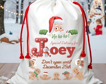 May include: White Christmas gift bag with red drawstring. Santa Claus peeks out from behind the letter "J" in the name "Joey". The bag has the text "Ho ho ho! Special Delivery for Joey Don't open until December 25th".