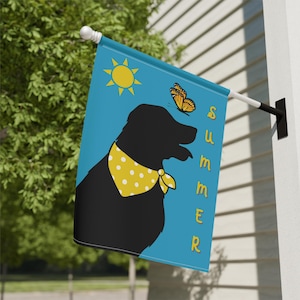 May include: A blue garden flag featuring a black silhouette of a dog wearing a yellow polka dot bandana. The flag also includes a yellow sun and a butterfly. The word "SUMMER" is written vertically on the right side of the flag.