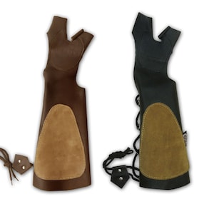 May include: Two leather archery arm guards with adjustable straps. One is brown with a tan suede patch and the other is black with a green suede patch.